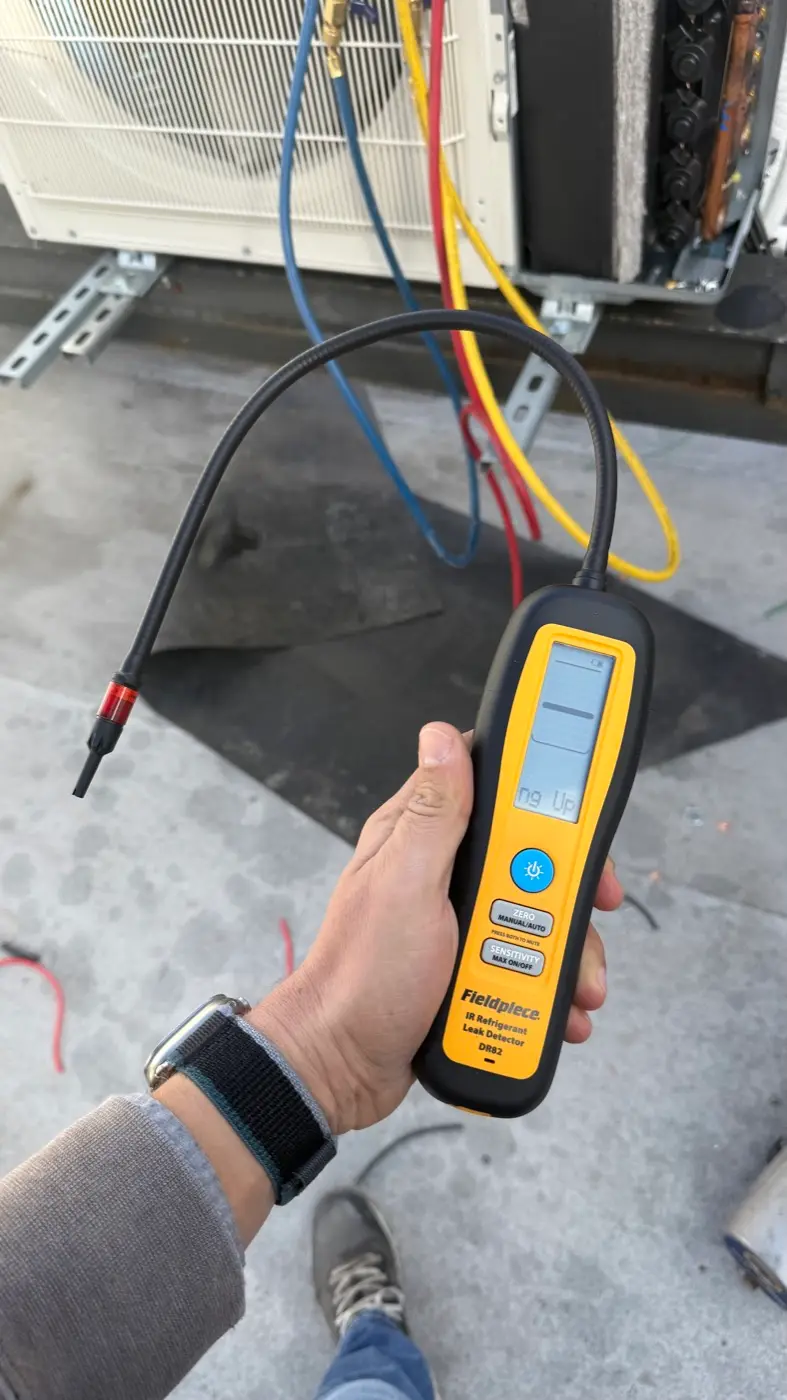 Checking a rooftop condenser for refrigerant leaks with an infrared detector