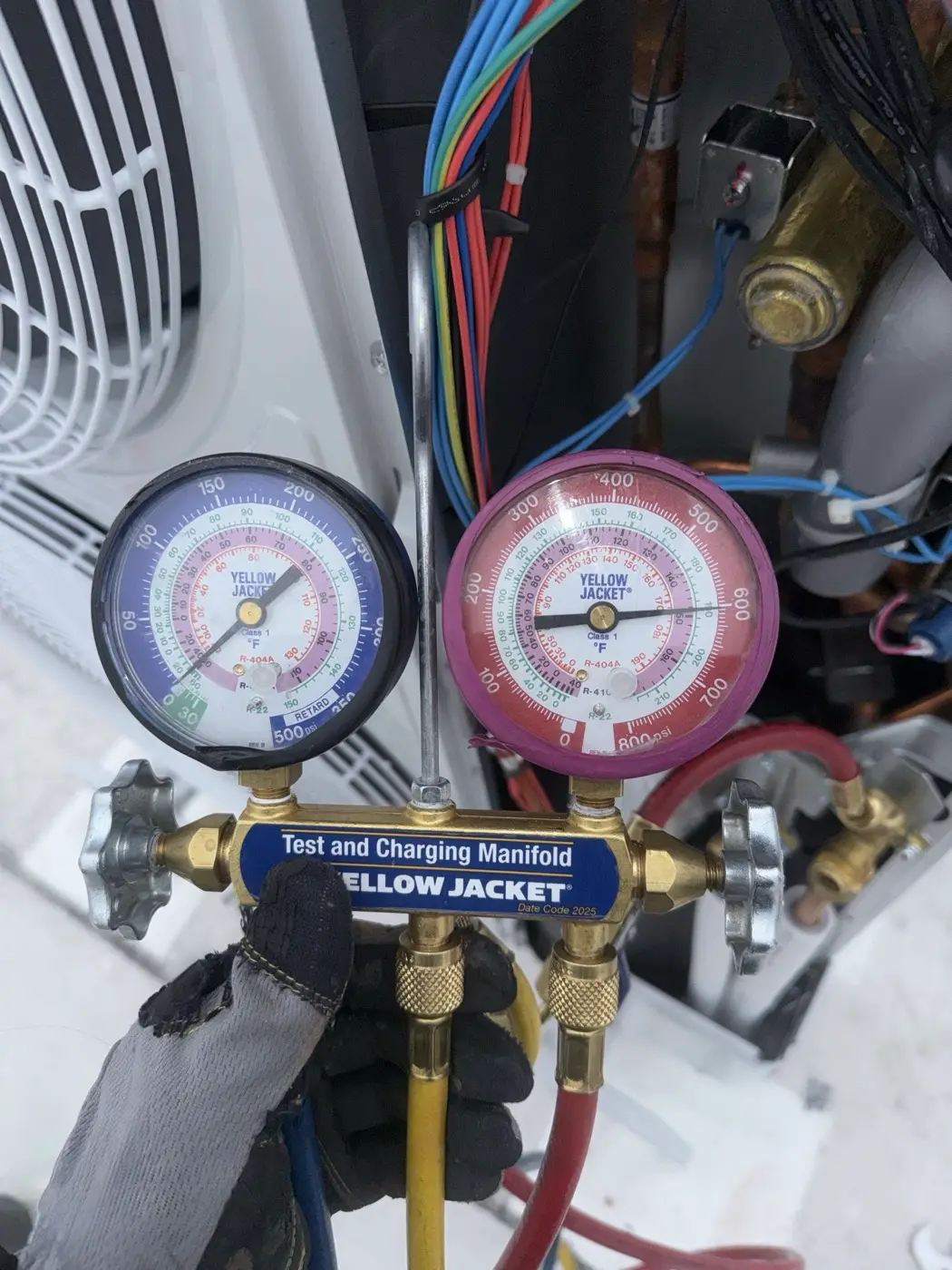 Checking refrigerant pressures with a manifold gauge on an outdoor unit
