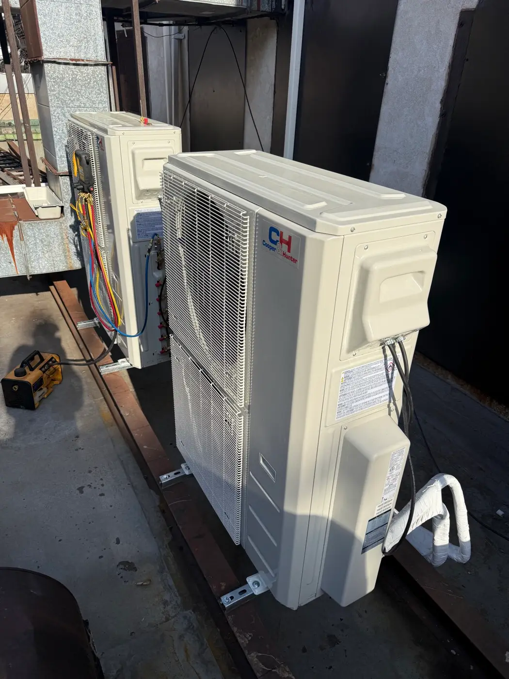 Two Cooper&Hunter condensers mounted and connected on a rooftop