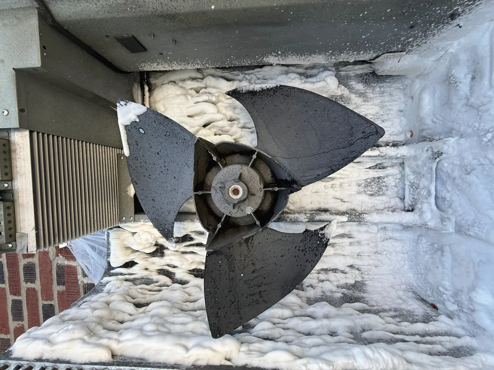 Iced-over condenser fan on a New York winter service call